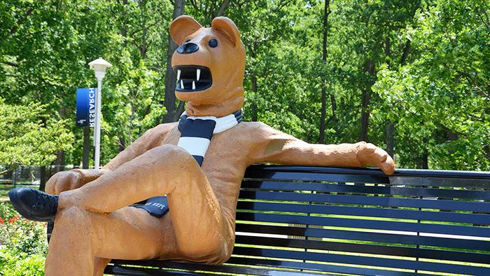 Statue of the Nittany Lion seated on a bench